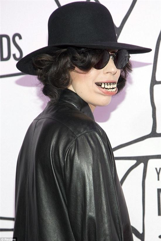 Incognito: She wore a short black curly wig and hat and sported a milky white complexion