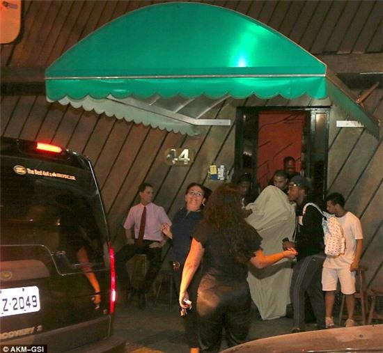 Nothing to see here! Justin Bieber and his minders do their best to make a hasty exit from the brothel in Brazil 