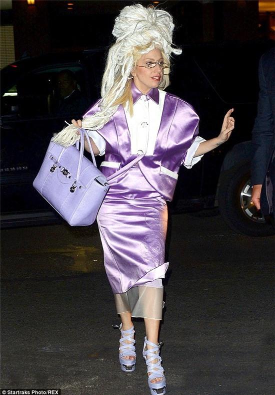 Monochromatic: The 27-year-old pop star toted a lavender purse with her strappy purple platforms
