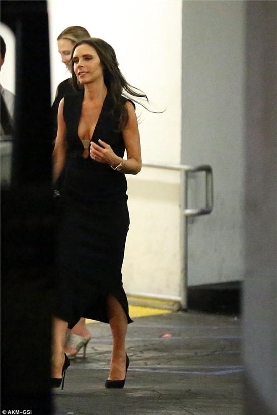 Woman in black: The former Spice Girl showed plenty of cleavage in the deep V-fronted sleeveless gown, which she teamed with classic black high heels