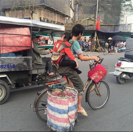 Nguoi cha diu con dap xe di nhat rac gay xuc dong hinh anh 2