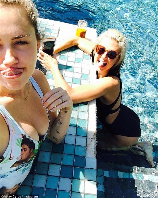 Pool party: Miley Cyrus wore a new ring on the fourth finger of her left hand in an Instagram snap she posted on Sunday, she captioned simply, 'pool daaaaaze', without mentioning the new bling