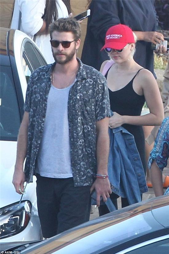 Are these two now one?: The ring sparked rumours that the 23-year-old and her beau Liam Hemsworth, seen on Sunday going for lunch at Nobu in Malibu, had tied the knot although it seems unlikely