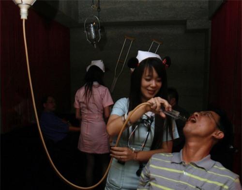 Hospital-themed restaurant A waitress dressed as a nurse serves a customer a drink through a hospital drip at a restaurant in Taiwan.