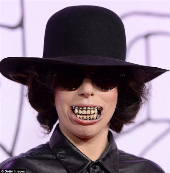 Life imitating art: Gaga sports the same scary smile on the cover of her new single Dope 