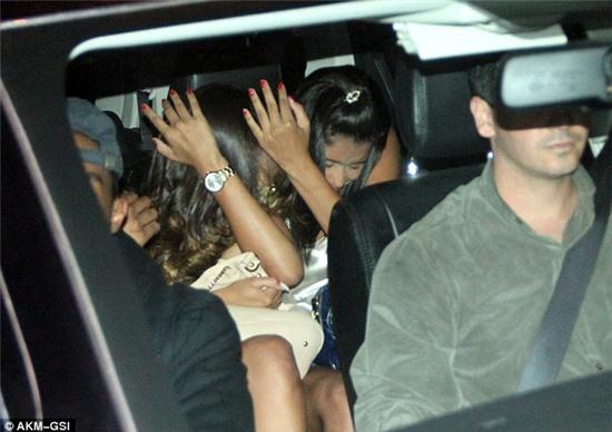 Swift exit: Two ladies from the establishment were seen hiding as they left in a vehicle behind Justin 