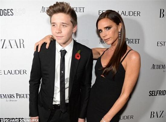 Gazing at the aspiring footballer adoringly, Victoria looked proud as punch at the distinguished young man her eldest child had grown up to be