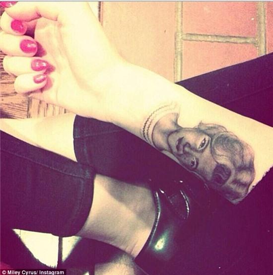 New ink: Miley Cyrus has had her grandmother's portrait immortalised in ink on her arm 