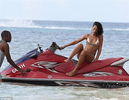 Break time: The Bajan star jumps off the jet ski to relax with her friends