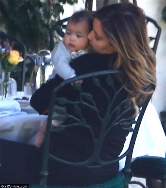 Showered with love: Little North West got plenty of kisses from her mother Kim Kardashian in Santa Barbara on Thursday
