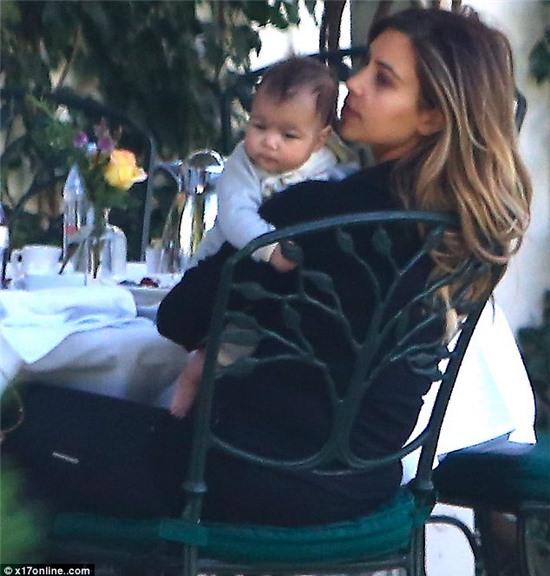 Coo: The 33-year-old was also seen whispering into her baby girl's tiny ears as she held her close