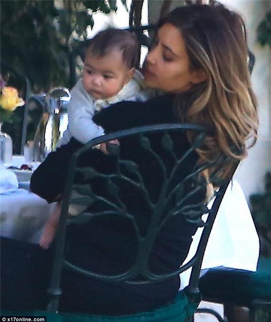 The apple of her eye: Kim couldn't stop gazing adoringly at North in between kissing her chubby little cheeks