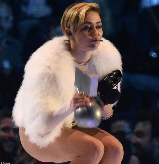 What a dope! Miley didn't seem to care who saw as she puffed away on her cigarette on stage 