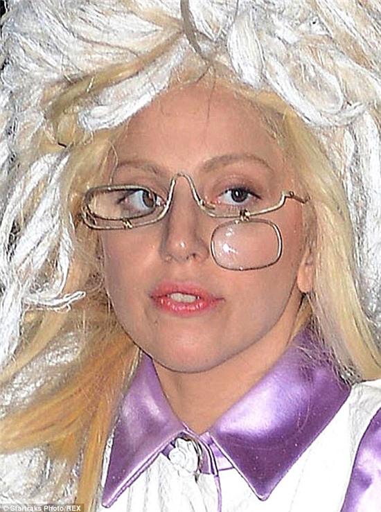 Seeing straight: Gaga - born Stefani Germanotta - accessorised her silky menswear-inspired frock with bizarre, broken spectacles