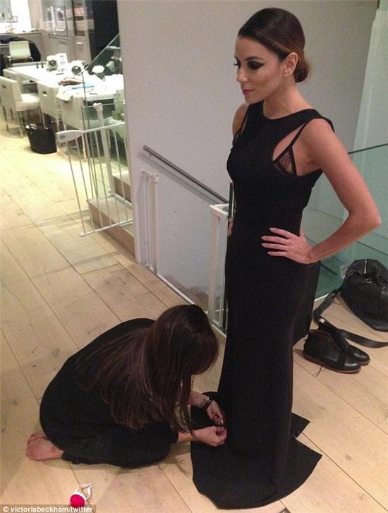 A friend indeed! Designer Victoria Beckham posted a photo of her making last-minute alterations to best friend Eva Longoria's gown ahead of the Fourth Annual Global Gift Gala in London on Tuesday