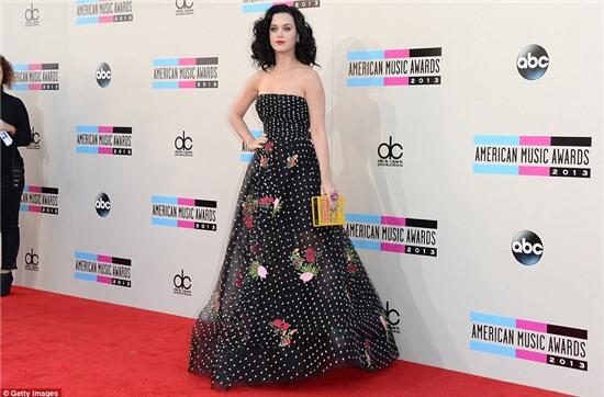 Spotted stunner: Katy Perry looked very demure and traditional in a strapless black and white dotty outfit decorated with flowers at the American Music Awards in Los Angeles on Sunday night 