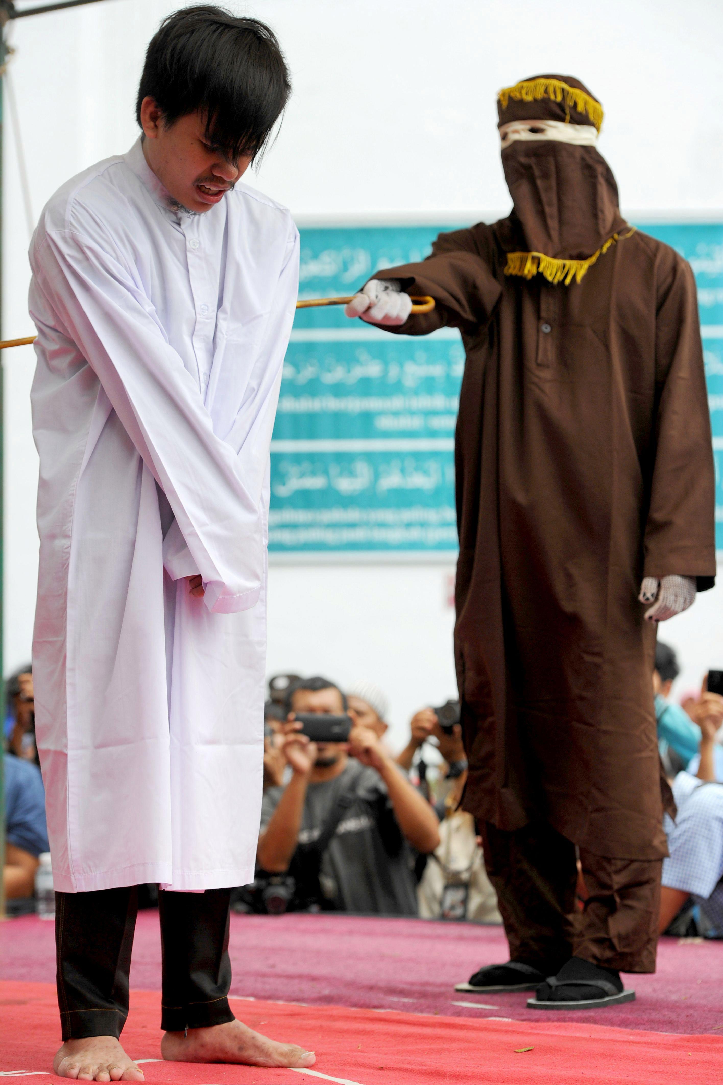 They were caned by sinister-looking masked men employed to uphold Sharia law