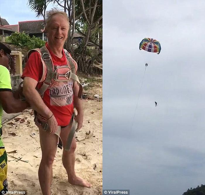 Hình ảnh người đàn ông bất ngờ rơi từ trên dù xuống biển khiến nhiều người hoảng sợ
