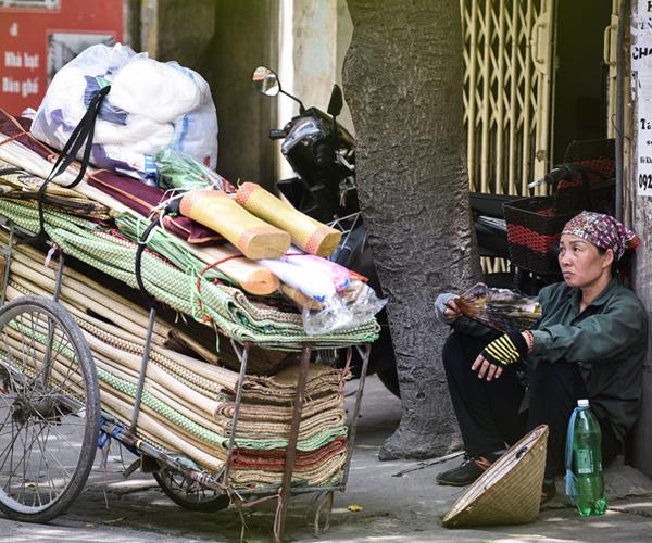 Một người bán hàng rong mệt nhoài sau khoảng thời gian di chuyển liên tục dưới trời nắng.