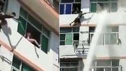 Kịch tính cảnh nhân viên cứu hỏa dùng vòi rồng ngăn người nhảy lầu tự tử