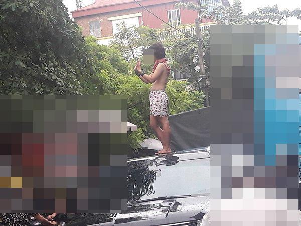 Cô gái trẻ gây sốc khi để ngực trần, trèo lên nóc ô tô nhảy múa trên phố Hà Nội-2