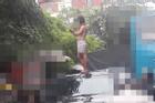 Cô gái trẻ gây sốc khi để ngực trần, trèo lên nóc ô tô nhảy múa trên phố Hà Nội