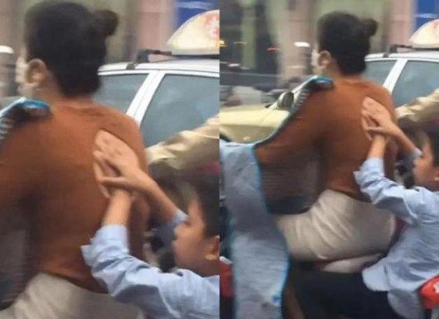 Mẹ trẻ mặc áo hớ hênh nhưng hành động che chắn của cậu con trai phía sau mới là tâm điểm-3