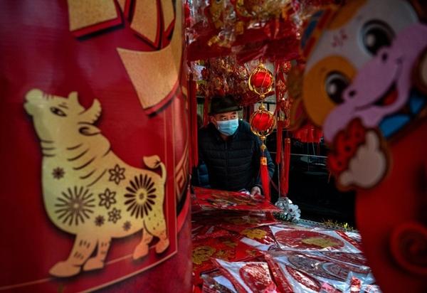 Một người đàn ông tại quán bán đồ trang trí tại Bắc Kinh. Ảnh: Getty Images.