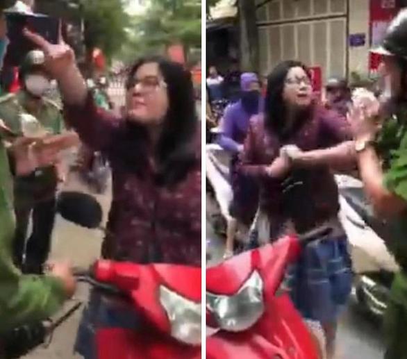 Bị giữ xe, người phụ nữ lao vào cắn công an rồi hét lên: Biết tao là ai không?-2