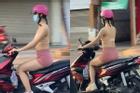 Cô gái mặc bra như bán khỏa thân hồn nhiên chạy xe trên đường