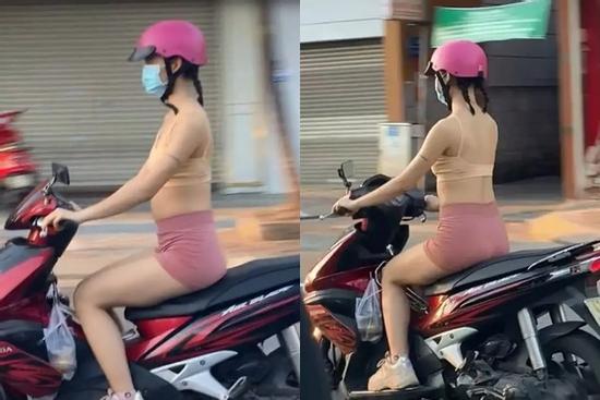 Cô gái mặc bra như bán khỏa thân hồn nhiên chạy xe trên đường