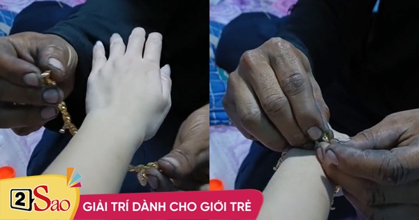 Husband bought a gold bracelet for his wife with his hands looking like he wanted to cry