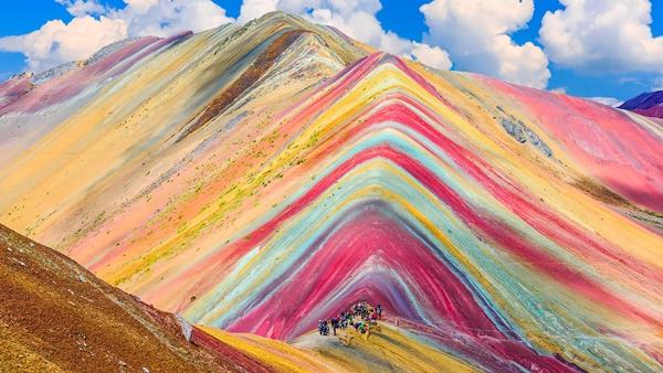 What are the vibrant colors of the fairy-like rainbow mountains in Peru painted with?-1