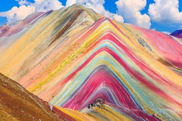 What are the vibrant colors of the fairy-tale rainbow mountains in Peru painted with?