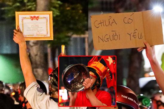 CĐV đánh thủng nồi, mang giấy khen, biển 'chưa có người yêu' đi bão