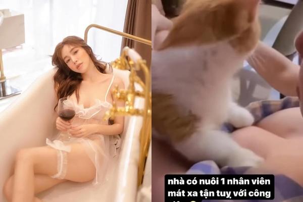 Elly Tran shows off the scene of giving her pet cat a round 1 massage