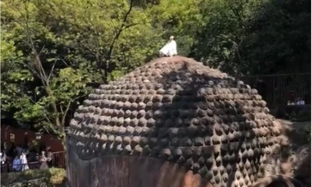 Nữ du khách gây sốc khi trèo lên đầu tượng Phật cao nhất Trung Quốc ngồi thiền-1