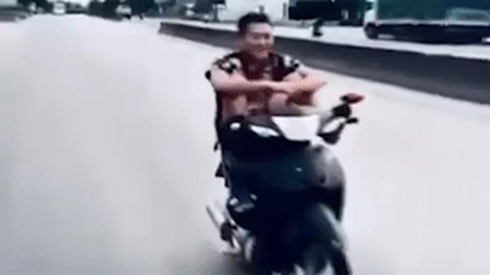 Nam thanh niên dùng chân lái xe máy, làm xiếc trên quốc lộ-1