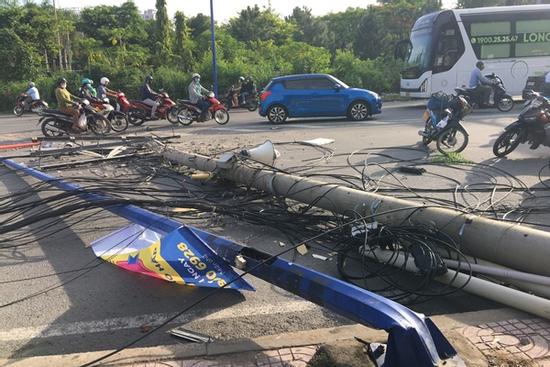 Xe container kéo sập trụ đèn và cột điện, 2 mẹ con bị thương