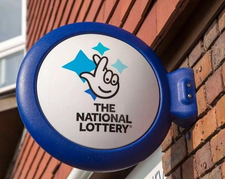 0wall-mounted-sign-for-the-national-lottery-amesbury-wiltshire-england-uk-17165966.jpeg